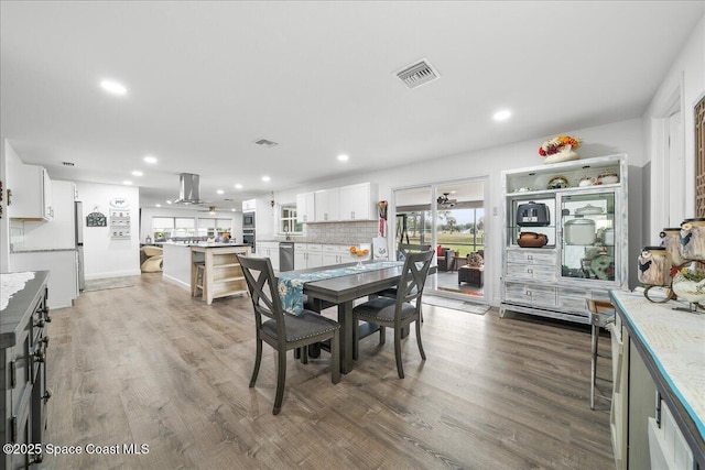 1253 Saint Andrews Dr, Rockledge, FL 32955 - dining room featuring visible vents, recessed lighting, and wood finished floors