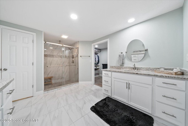 1253 Saint Andrews Dr, Rockledge, FL 32955 - full bathroom featuring a spacious closet, a shower stall, recessed lighting, vanity, and marble finish floor