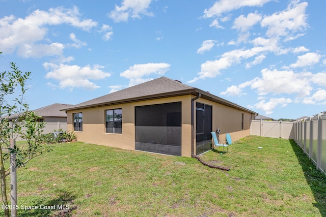 6575 Topaz Dr, Grant, FL 32949 - rear view of property featuring a fenced backyard, a lawn, and stucco siding
