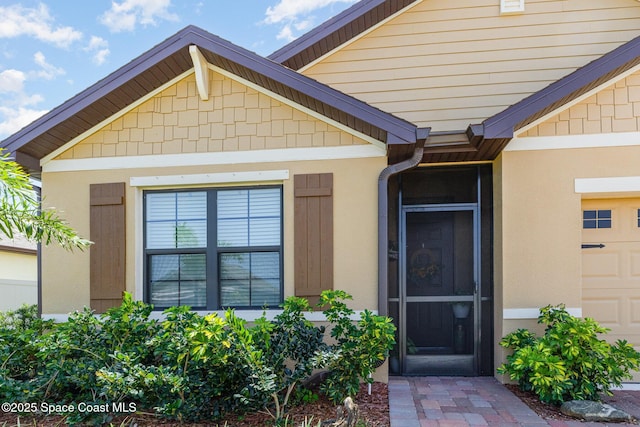 6575 Topaz Dr, Grant, FL 32949 - property entrance featuring an attached garage and stucco siding