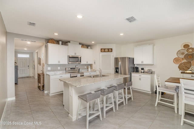 6575 Topaz Dr, Grant, FL 32949 - kitchen featuring light tile patterned floors, visible vents, a sink, and appliances with stainless steel finishes
