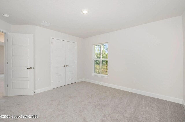 1099 Hanson Ave SW, Palm Bay, FL 32908 - unfurnished bedroom with baseboards, carpet flooring, and a closet