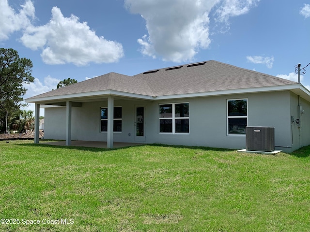 1099 Hanson Ave SW, Palm Bay, FL 32908 - back of property featuring stucco siding, a lawn, roof with shingles, and a patio