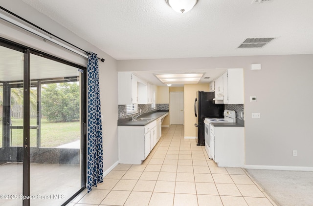 kitchen featuring visible vents, dark countertops, white electric range, and light tile patterned floors
