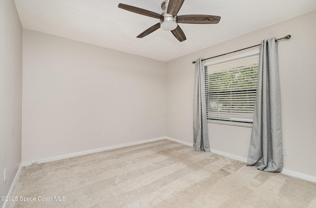 spare room featuring ceiling fan, carpet flooring, and baseboards