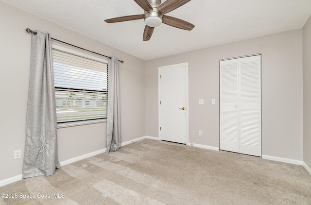 unfurnished bedroom with a closet, baseboards, and carpet