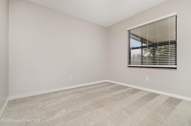 empty room with baseboards and carpet floors