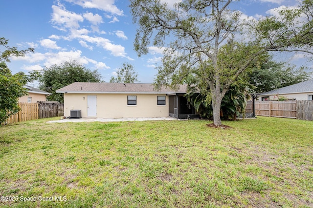 back of property with central AC unit, a fenced backyard, a patio area, and stucco siding