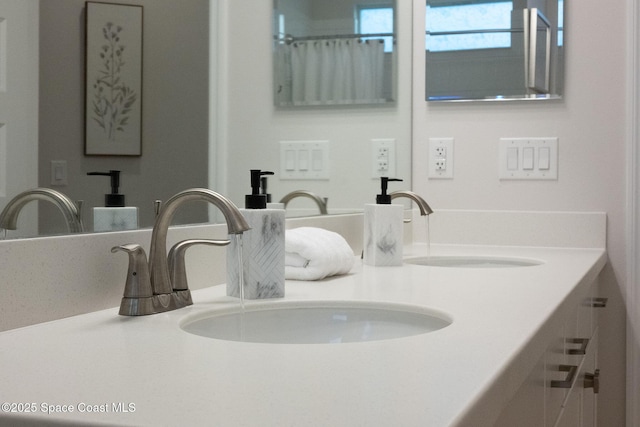 bathroom with a sink and double vanity