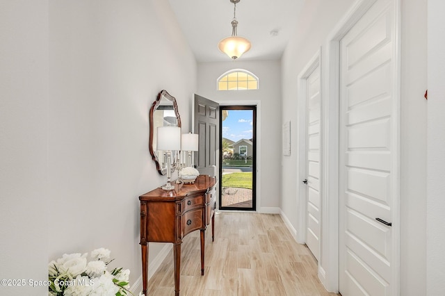 entrance foyer with light wood-style flooring and baseboards