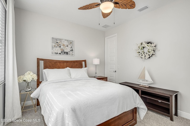 bedroom featuring light carpet, a ceiling fan, visible vents, and baseboards