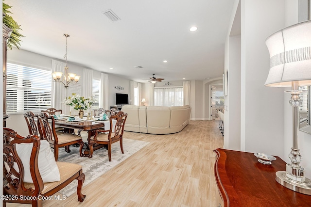 dining space with recessed lighting, visible vents, light wood finished floors, and ceiling fan with notable chandelier