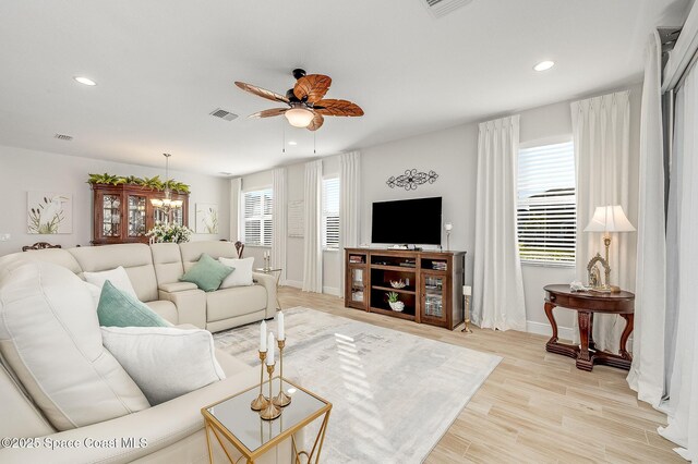 living area with baseboards, visible vents, recessed lighting, and ceiling fan
