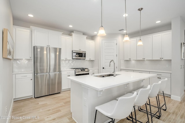 kitchen with recessed lighting, tasteful backsplash, stainless steel appliances, and a sink