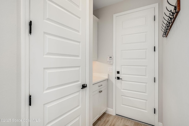 entryway featuring baseboards and light wood-type flooring
