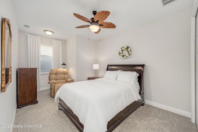 carpeted bedroom with visible vents, baseboards, and ceiling fan