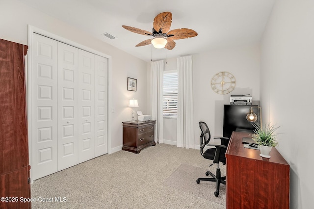 office area with carpet floors, a ceiling fan, visible vents, and baseboards