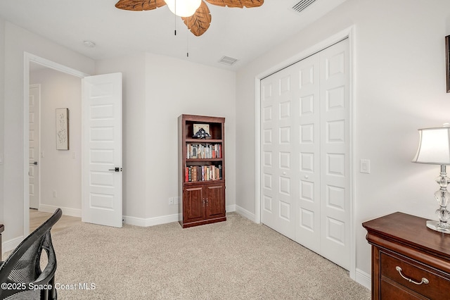 office space with light carpet, baseboards, visible vents, and ceiling fan
