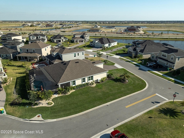 drone / aerial view with a residential view and a water view