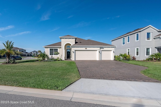 view of front of house featuring stucco siding, a front lawn, decorative driveway, and a garage