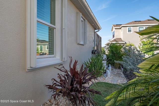 view of side of home with stucco siding