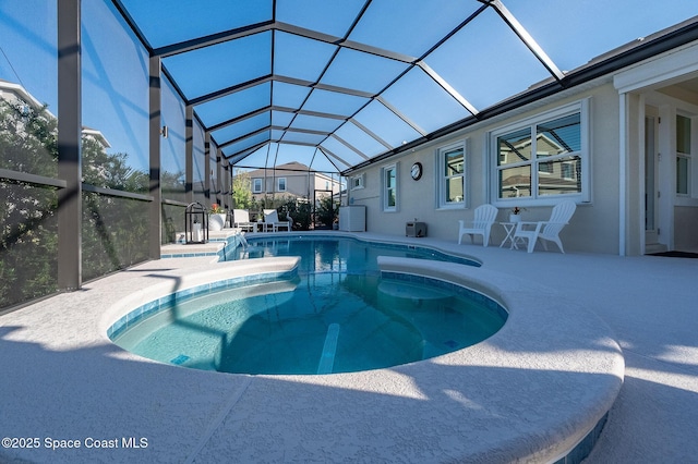 outdoor pool featuring a lanai and a patio area