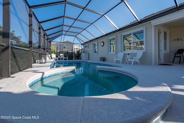 view of pool with a pool with connected hot tub, a lanai, and a patio