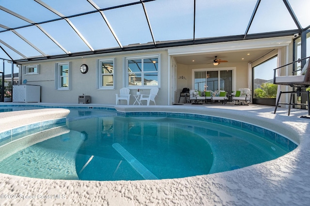 outdoor pool featuring a lanai, a ceiling fan, central AC unit, and a patio