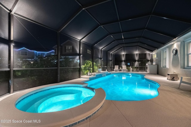 view of pool featuring a lanai, a patio area, and a pool with connected hot tub
