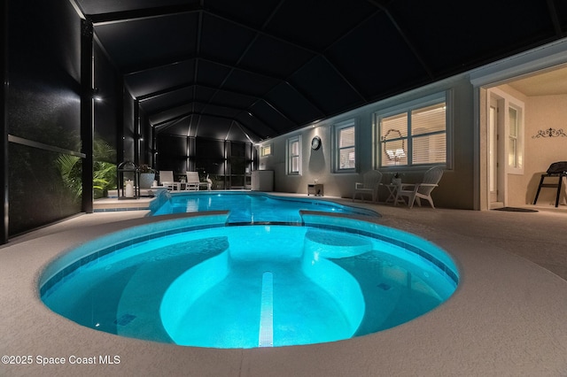 outdoor pool featuring a patio area and glass enclosure