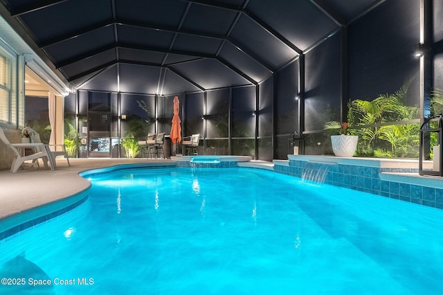 view of pool with a pool with connected hot tub, a lanai, and a patio