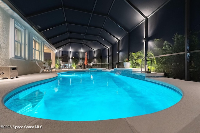 view of pool with a lanai, a patio, and a pool with connected hot tub