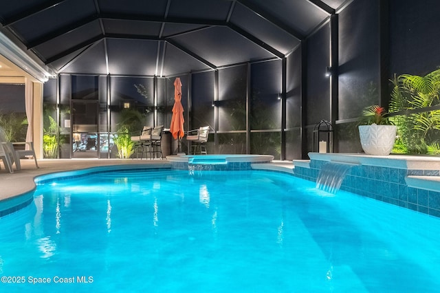 view of swimming pool with a lanai and a pool with connected hot tub