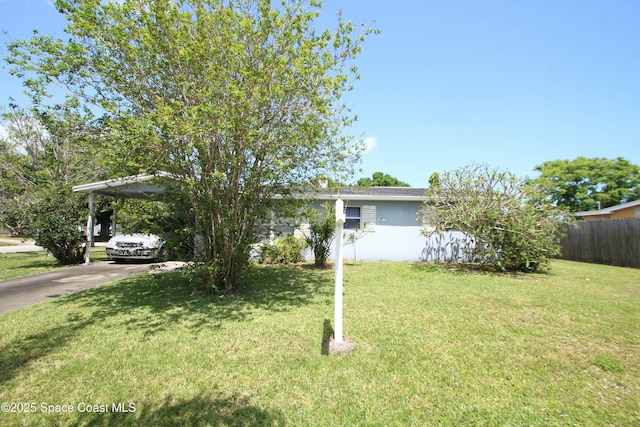 1798 Hudson Cir S, Melbourne, FL 32935 - ranch-style home featuring a carport, fence, a front lawn, concrete driveway, and stucco siding