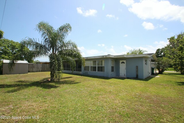 1798 Hudson Cir S, Melbourne, FL 32935 - back of house with a yard and stucco siding