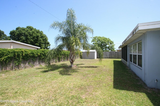 1798 Hudson Cir S, Melbourne, FL 32935 - view of yard with a storage unit, a fenced backyard, and an outbuilding