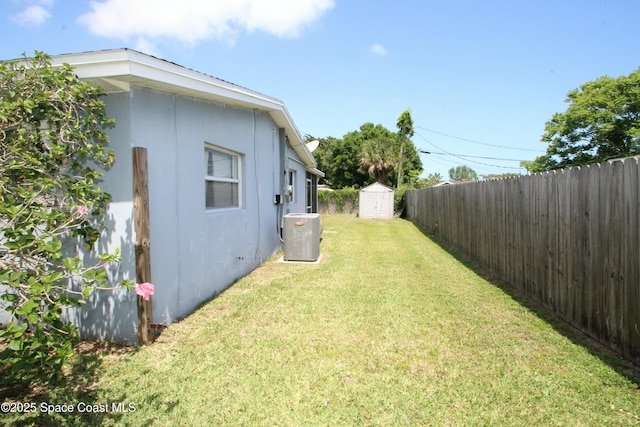 1798 Hudson Cir S, Melbourne, FL 32935 - view of yard with central air condition unit, an outbuilding, a fenced backyard, and a storage unit