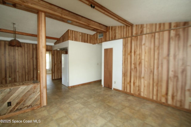 1798 Hudson Cir S, Melbourne, FL 32935 - unfurnished living room with lofted ceiling with beams, tile patterned floors, and wood walls