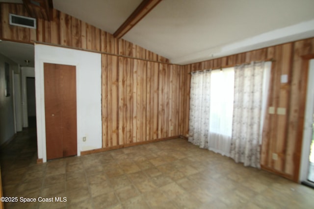 1798 Hudson Cir S, Melbourne, FL 32935 - spare room with wooden walls, visible vents, and lofted ceiling