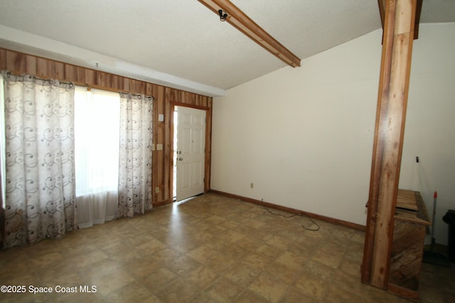 1798 Hudson Cir S, Melbourne, FL 32935 - interior space with baseboards and lofted ceiling with beams