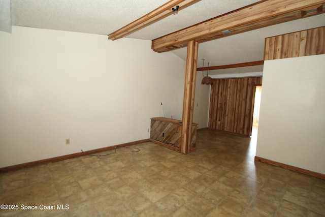 1798 Hudson Cir S, Melbourne, FL 32935 - spare room with baseboards, lofted ceiling with beams, and a textured ceiling