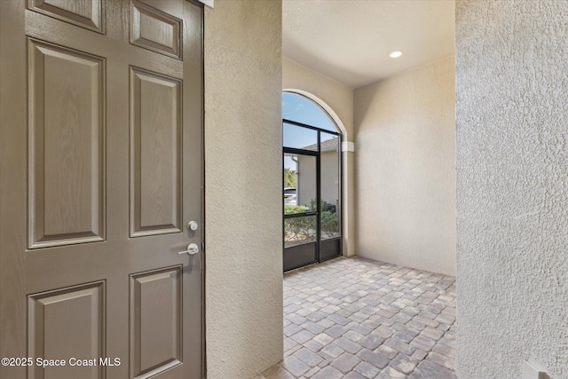 view of exterior entry featuring stucco siding