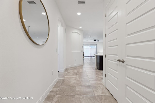 hall featuring recessed lighting, visible vents, and baseboards