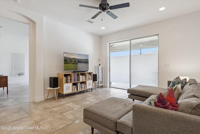 living area featuring baseboards, a ceiling fan, visible vents, and recessed lighting
