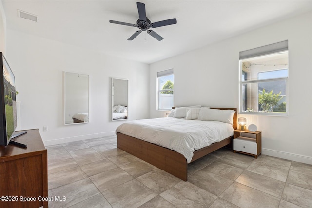 bedroom featuring visible vents, baseboards, a ceiling fan, and light tile patterned floors