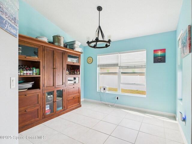 2515 SE Marquez Ave SE, Palm Bay, FL 32909 - dining room featuring a notable chandelier, baseboards, and light tile patterned flooring