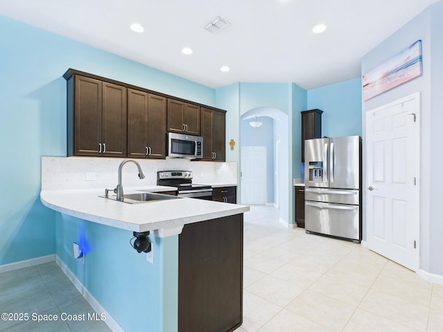 2515 SE Marquez Ave SE, Palm Bay, FL 32909 - kitchen featuring tasteful backsplash, visible vents, arched walkways, a sink, and stainless steel appliances
