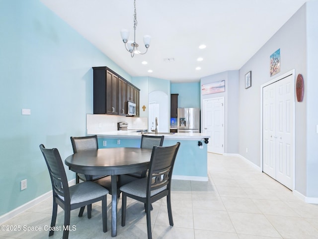 2515 SE Marquez Ave SE, Palm Bay, FL 32909 - dining room with an inviting chandelier, baseboards, and light tile patterned floors