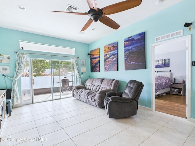 2515 SE Marquez Ave SE, Palm Bay, FL 32909 - living room featuring light tile patterned floors, visible vents, baseboards, and a ceiling fan
