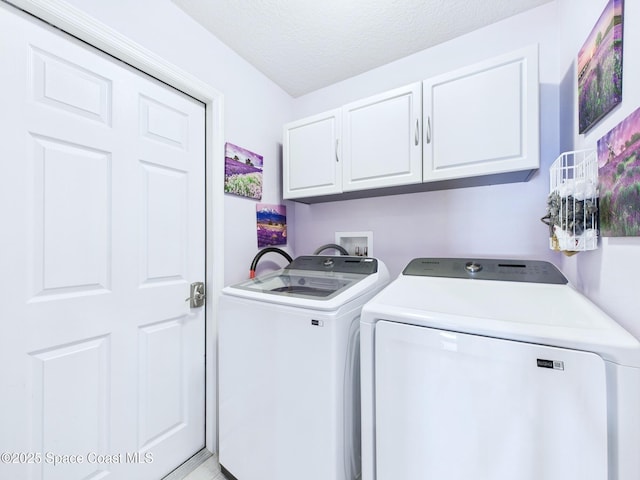 2515 SE Marquez Ave SE, Palm Bay, FL 32909 - laundry area featuring a textured ceiling, separate washer and dryer, and cabinet space